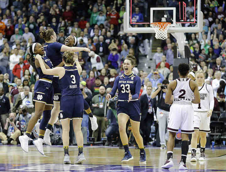 Notre Dame players celebrate their win on a three-pointer by guard Arike Ogunbowale (24) following the NCAA Women's Final Four championship game against the Mississippi State Lady Bulldogs at Nationwide Arena. Notre Dame won 61-58 to claim their second national championship.  (Adam Cairns / The Columbus Dispatch)